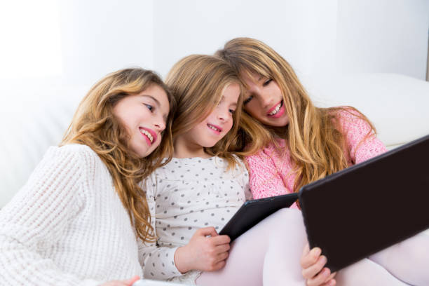 istock three kid sister friends girls group playing together with tablet pc 1340303191