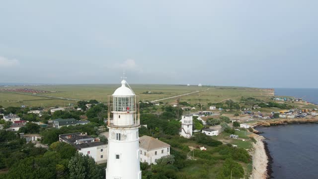 high white lighthouse in the city of Olenevka in the Crimea