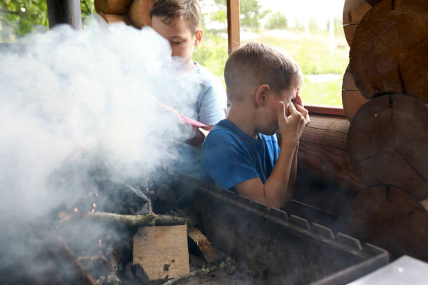 istock Two children kindle firewood on grill in gazebo 1340303434