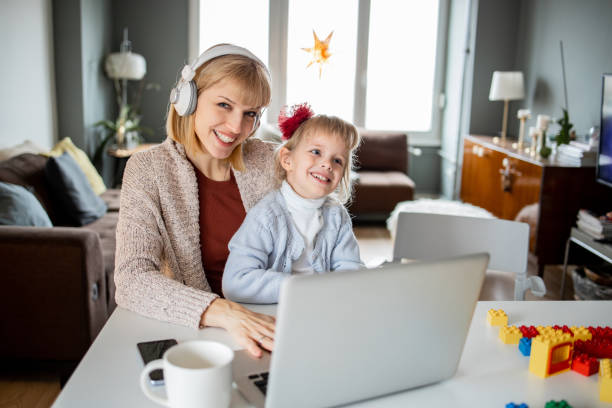 istock Woman working from home while her daughter is playing 1340303994
