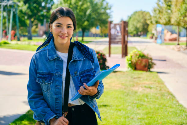 College Student on Campus A young woman college student, standing on campus. community college stock pictures, royalty-free photos & images