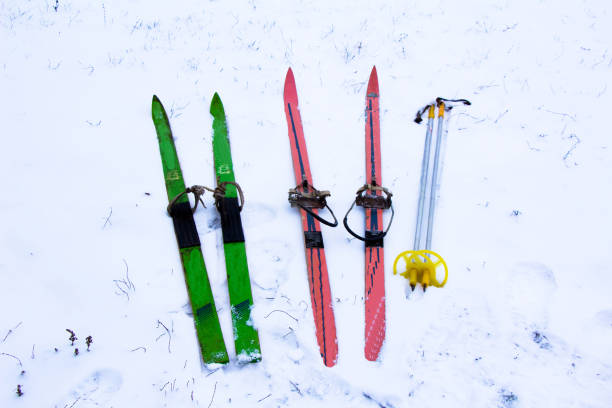 istock Old Soviet skis with poles lie in the snow 1340306965
