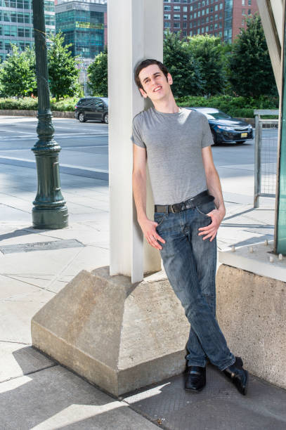 istock Young man standing outdoors in New York City, looking up, thinking 1340308994