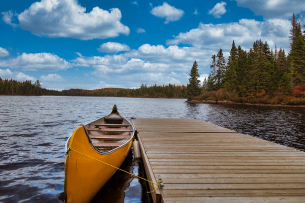 orange yellow canoe on a lake. - moored boats imagens e fotografias de stock