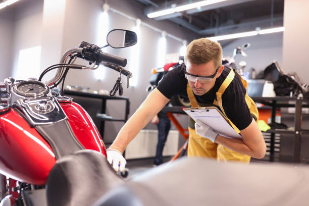 istock Male locksmith diagnoses a motorcycle at service center closeup 1340313067