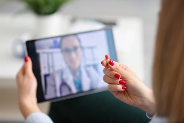 istock Woman communicates remotely with doctor via video call 1340313093