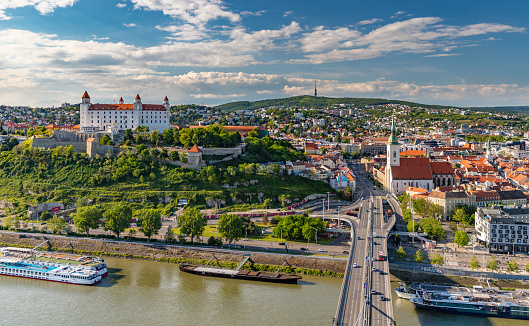 Bratislava, Slovakia - May 10, 2019: A picture of the landmarks of Bratislava: St. Martin's Cathedral, the Bratislava Castle and the Bridge SNP.