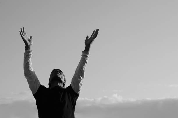 istock man praying to god with arms outstretched 1340318243