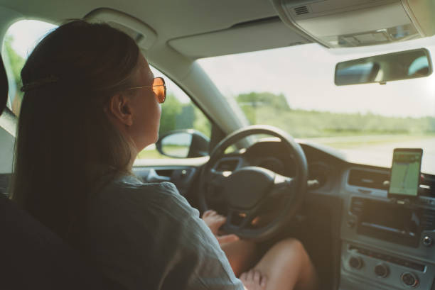istock Woman driving a car in summer time. 1340325238
