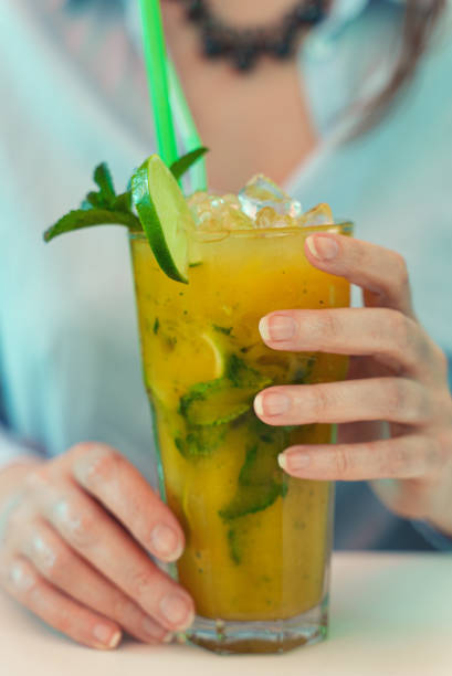 istock Woman holds delicious handmade lemonade with lime. 1340325240