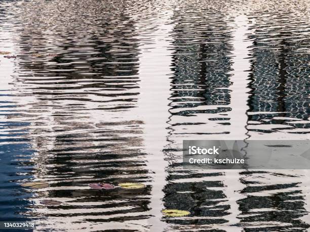 Lake Reflections Of Houses In Coastal Town Stock Photo - Download Image Now - Distorted, Water Surface, Abstract