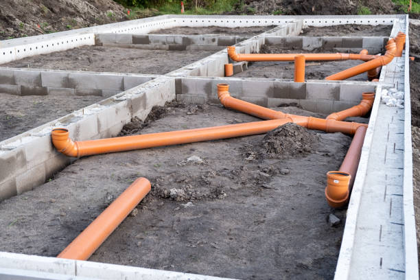 istock Ready Made cement foundation and Prepared Drainage System from Plastic pipes made by plumber in the ground during the building of a modular house in Europe. Construction Engineering concept 1340331383