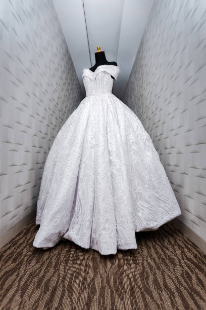 Beautiful wedding dress is put on the black mannequin.