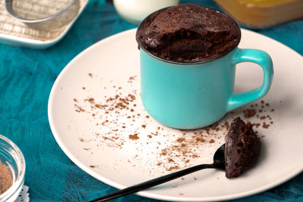istock mugcake is microwaved. Homemade cupcake in a mug is on a plate. 1340340265
