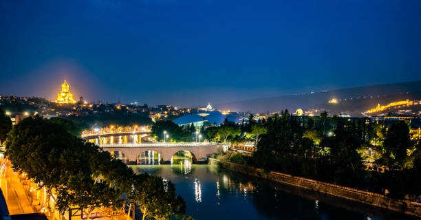 istock Scenic view of Mtkvari river and Holy Trinity Cathedral at night 1340344139