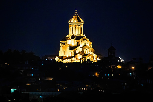 Scenic view of Holy Trinity Cathedral at night illuminated in Tbilisi Georgia