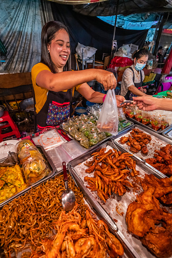 Thai street food sellers at the night market in Chiang Mai, Northern Thailand