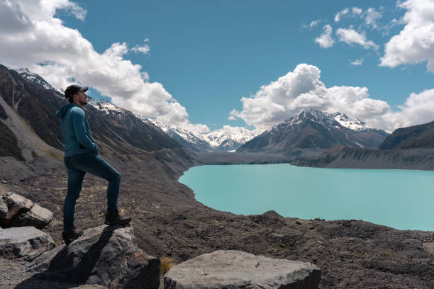 istock Man standing on a rock and looking at landscape in Tasman lake and mount. New Zealand 1340347328