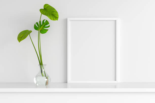 istock Leaves in glass vase with frame mockup, 3D rendering 1340353415