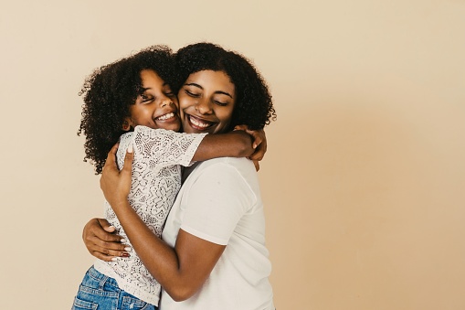 happy family of single mother and daughter together hugging.