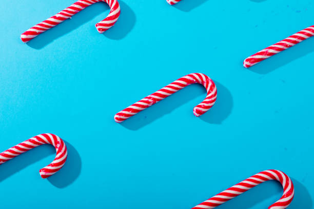 istock Composition of multiple rows of candy canes on blue background 1340358014