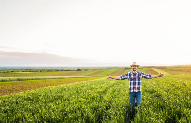 istock Young farmer loves his agricultural field. 1340358164
