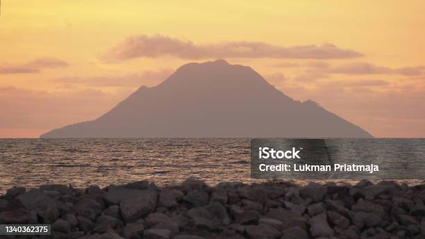 Mount At The Middle Of The Sea At Sunset With Rock Hiri Island Ternate Maluku Utara Indonesia Stock Photo Stock Photo - Download Image Now
