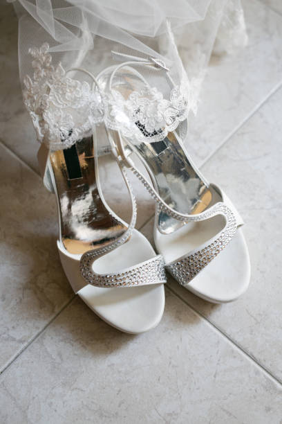 istock White wedding shoes with glitter and veil 1340364989