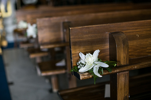White flowers on the pew of a church