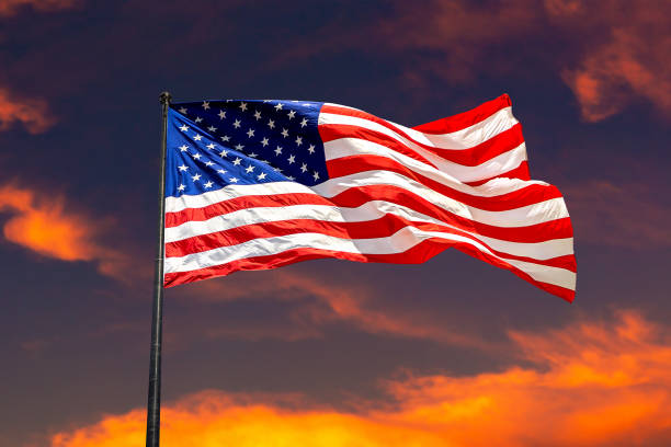 istock USA flag waving against sunset sky 1340381104