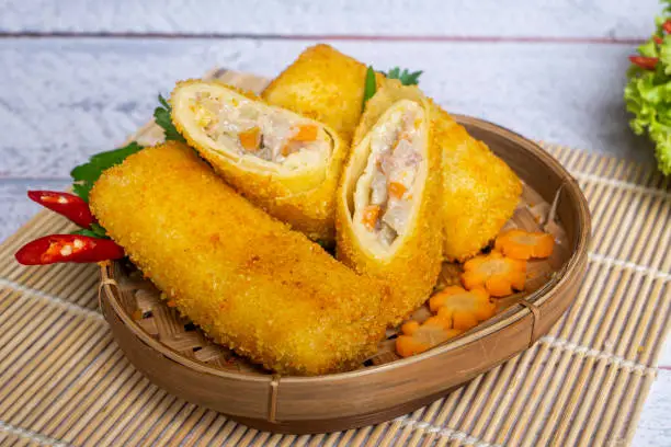Delicious Risoles or Risol Vegetable is a typical Indonesian traditional street food made from flour skin, meat and vegetables stuffing inside, decorated with chilies and woven bamboo
