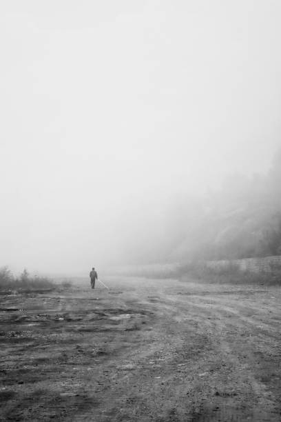 istock Man with stick in fog 1340388649