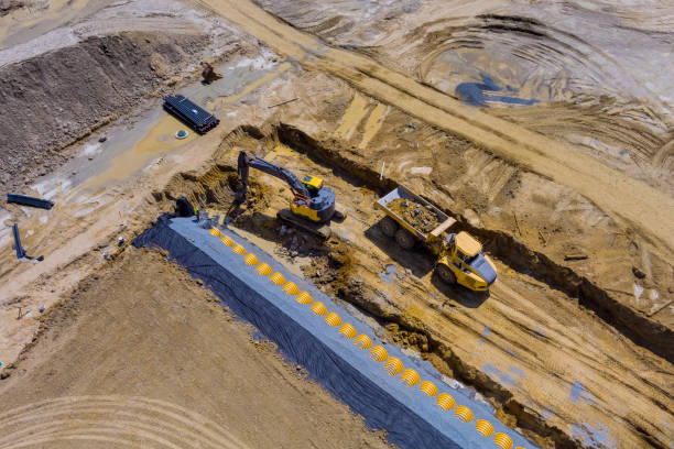 istock Aerial panoramic view at earthworks construction site for sewerge construction trench for laying external sewage drainage system 1340389726