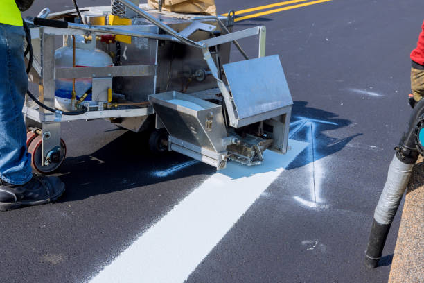 istock Workers apply white paint a road marking the stripes with a reflective powder on the asphalt 1340389731