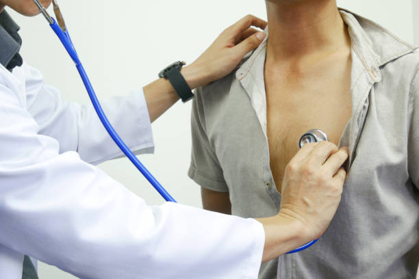 istock Man doctor's hand holds the patient's cardiac data sheet. And doctors are using Stethoscope to check men's heart health. 1340395413