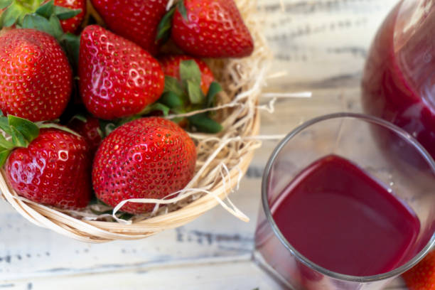 strawberry in basket and on table on wooden background, strawberry juice in jug - 6206 imagens e fotografias de stock