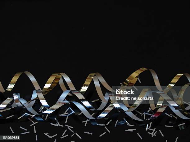 Silver And Gold Streamers On Black Stock Photo - Download Image Now - Black Background, Confetti, Silver - Metal