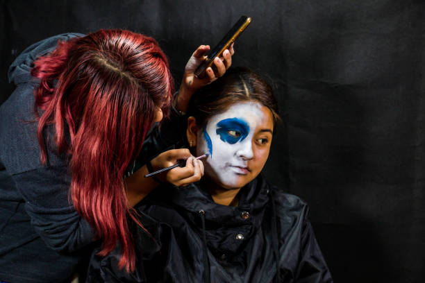 istock Backstage makeup. Women doing Halloween makeup, people in professional makeup artist training. 1340400423