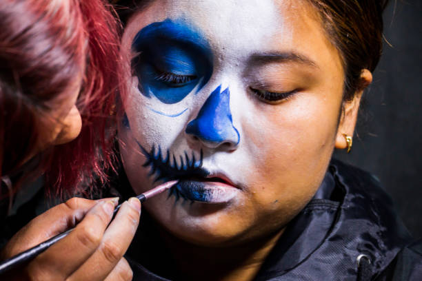 istock Backstage makeup. Women doing Halloween makeup, people in professional makeup artist training. 1340400430