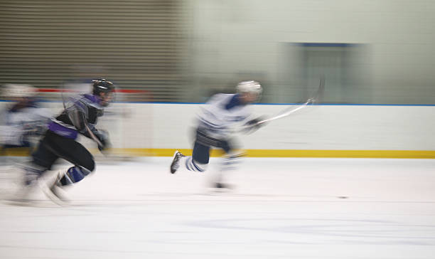 istock Two ice hockey players making a break for the puck 134040100