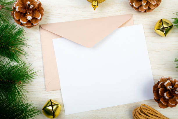 istock Composition of white card with copy space, envelope and christmas decorations on wooden background 1340404100