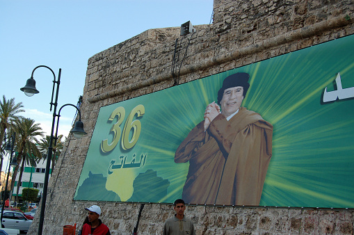 Tripoli, Libya - April 3, 2006: Celebratory poster of President Colonel Gaddafi on the wall of the Red Castle in the centre of Tripoli, Libya on a sunny afternoon.