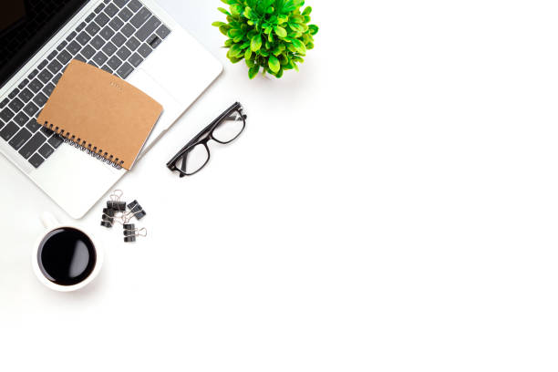 istock White office desk table with blank notebook, computer keyboard and other office supplies. Top view with copy space, flat lay. 1340404381