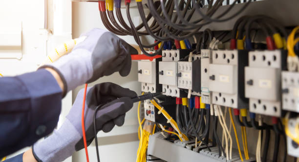 istock Electrician engineer tests electrical installations and wires on relay protection system. Adjustment of scheme of automation and control of electrical equipment. 1340404435