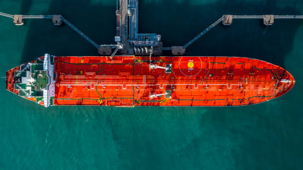 istock Aerial view tanker ship vessel unloading at port, Business import export oil and gas petrochemical with tanker ship transportation oil from dock refinery, Loading arm oil and gas offshore platforms. 1340407206