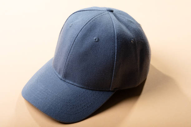 istock Composition of traditional peaked grey baseball cap on pale brown background 1340410258