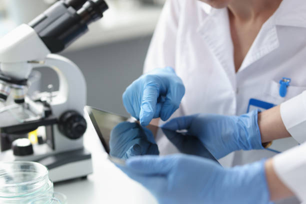 istock Scientists in sterile gloves hold tablet in laboratory closeup 1340411832