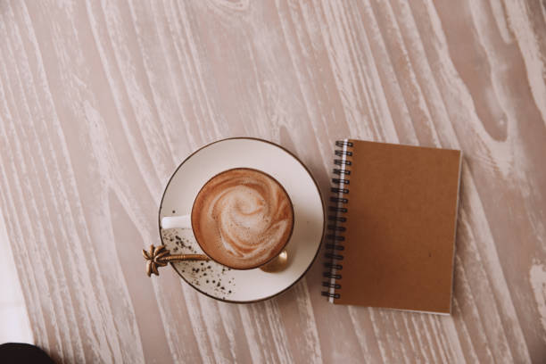 istock white cup of hot cappuccino on wooden light table background. 1340413105
