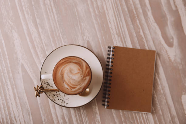 istock white cup of hot cappuccino on wooden light table background. 1340413115