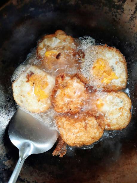 istock Frying egg in iron cooking pan - food preparation. 1340413552